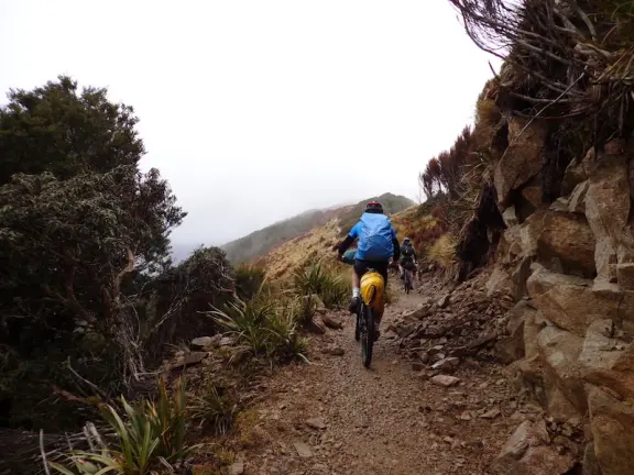 Mountain biker on the Paparoa Track on cloudy day