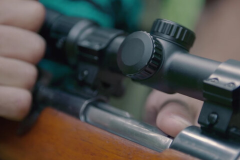 Thumbnail of Hunter holding bolt of rifle hunter safety