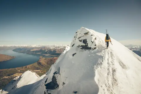Ski tourer on the Remarkables with Lake Wakatipu in the background