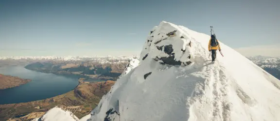 Ski tourer on the Remarkables with Lake Wakatipu in the background