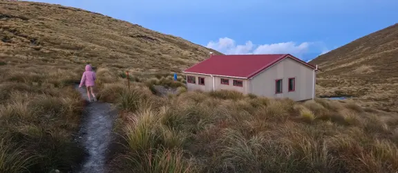 children walking along path towards Kime Hut 