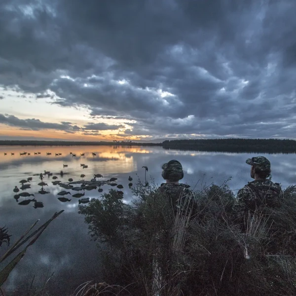 Duck hunters in maimai overlooking pond